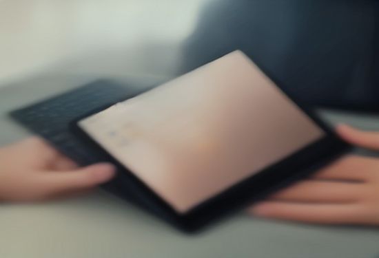 A realistic photo of a person typing sensitive information into a laptop with a blurred chat interface in an office setting